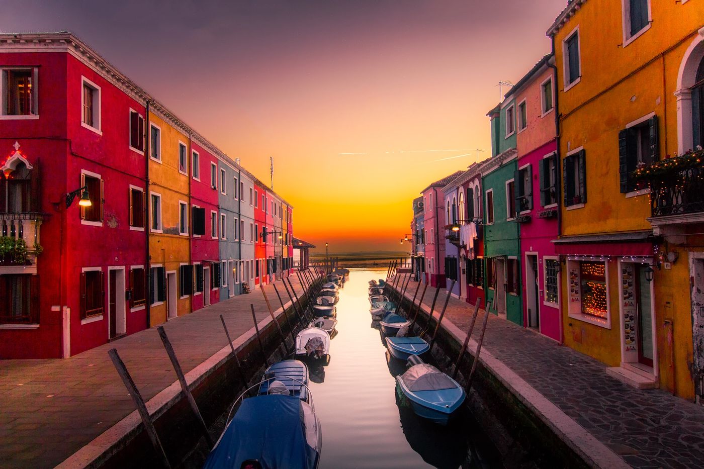 A calm canal at sunset with moored boats, representing the steady, planned retirement lifestyle we help clients work toward.